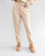 Person wearing beige pants and shoes on a white background
