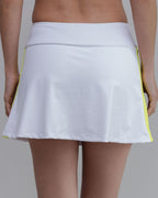White tennis skirt with yellow trim on a gray background