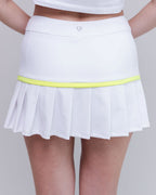 White tennis skirt with a yellow waistband on a plain background
