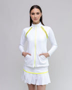 Woman wearing a white outfit with yellow accents on a gray background