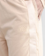 Close-up of a beige jacket with a logo on a light gray background