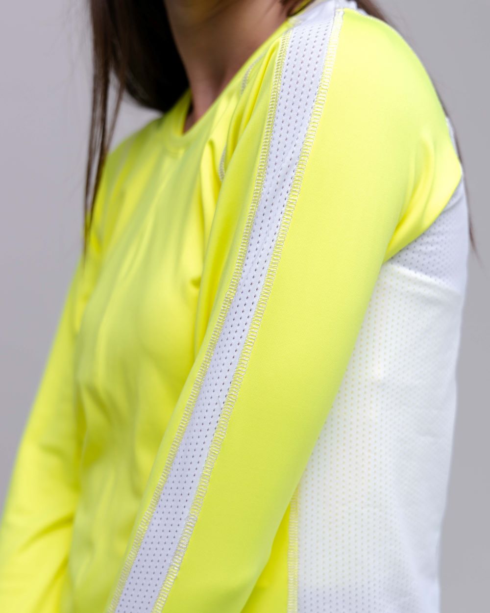Neon yellow and white outfit with a plain background
