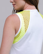 White tank top with neon yellow mesh back panel worn by a person.