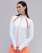Woman wearing a white jacket with orange accents on a gray background