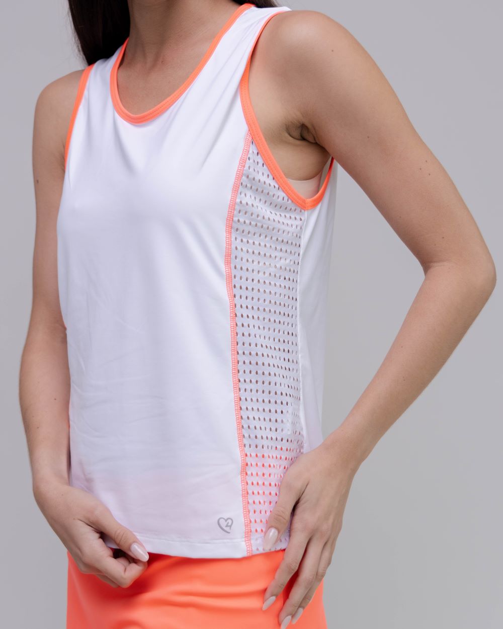 White tank top with orange trim worn by a person on a gray background