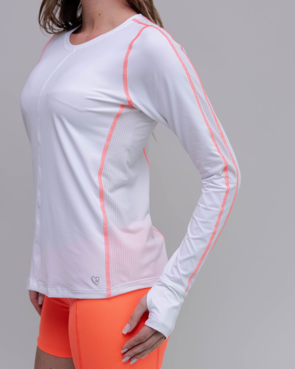 White long-sleeve athletic shirt with orange accents worn by a person on a gray background