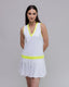 Woman wearing a white dress with yellow accents on a gray background